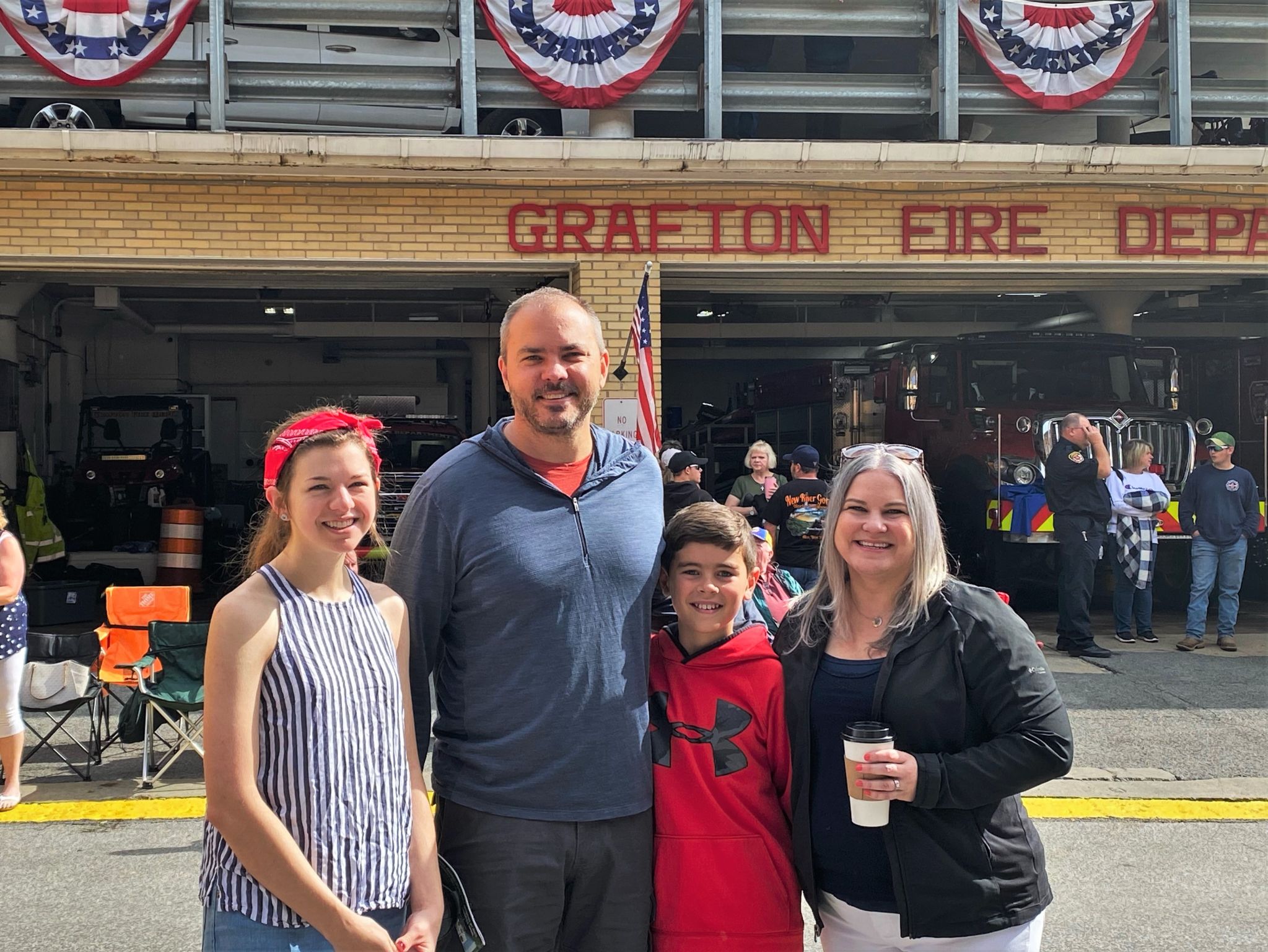 A group of four people standing in front of the Grafton Fire House